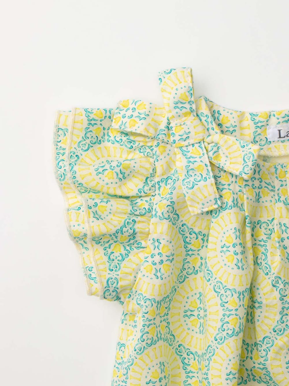 ロンパース・カバーオール|La Stella（ラ ステラ）タイル柄リボンギャザーロンパース